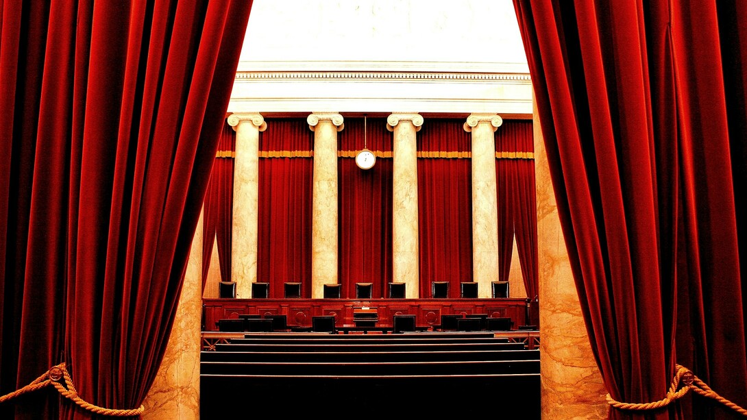 The seats of the U.S. Supreme Court, framed as a theater stage