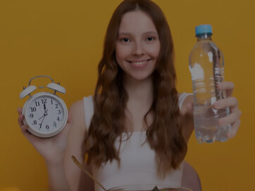 Promote a healthy lifestyle with a captivating medium shot of a woman surrounded by colorful fruits and vegetables, emphasizing the benefits of plant-based nutrition and its role in supporting healthy aging
