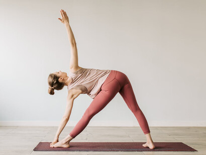 In Utthita Trikonasana, or extended triangle pose, she embodies the essence of balance and stability, showcasing the beauty of mindful movement