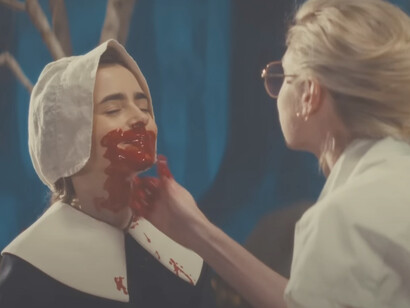 Lily Collins bathed in fake blood in a scene from MaXXXine