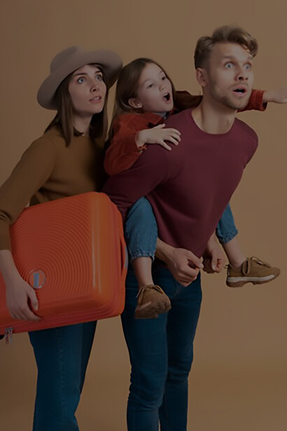 Embark on your next adventure with an enchanting image of a young family of three posing together before their travel vacation