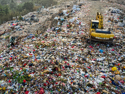 An excavator working at a landfill