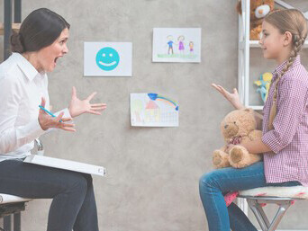 Close-up of a female therapist encouraging a young girl screaming in a therapy session, highlighting emotional dysregulation
