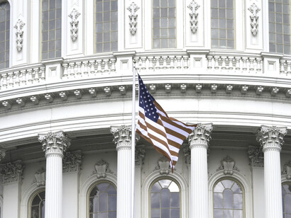 US government building, Washington DC, with US flag waving