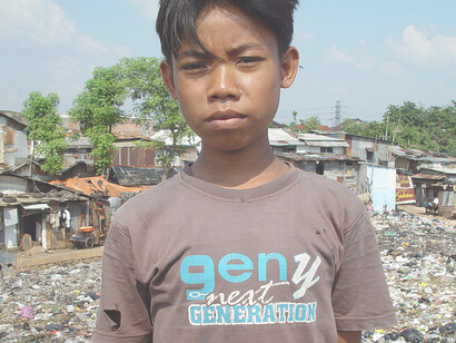 A young boy living on an East Cipinang garbage dump, Jakarta Indonesia. Picture taken by Jonathan McIntosh, 2004