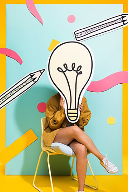 The essence of creativity with a portrait of a schoolgirl holding a large light bulb, symbolizing innovative thinking and inspiration