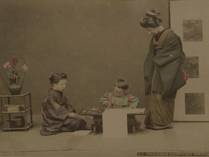 Kusakabe Kimbei, Children copyng the writting, 1880,hand couloured album silver photograph, 26,7 x 20,3 cm