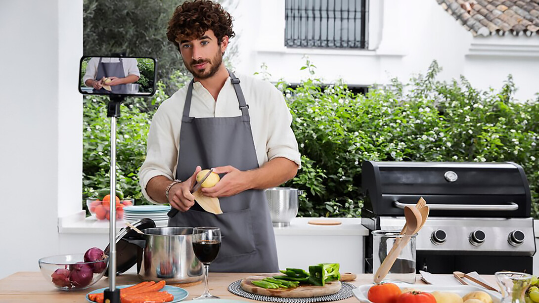A male vlogger, live-streaming his cooking, exemplifies the impact of social media on culinary trends as a food influencer