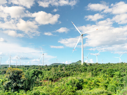 Wind turbines against the blue sky in green fields in Vietnam