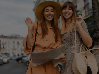 Trendy young women embarking on a European adventure, showcasing spring fashion while discovering iconic landmarks