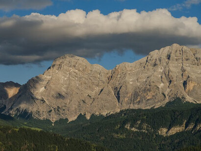 The human being, finding solitude mmidst the mountain ranges of existence