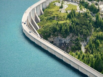 A dam holding off the water reservoir from as a means of storing the capacity
