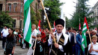 A person from Abkhazia holding the Apsny (Abkhaz) flag