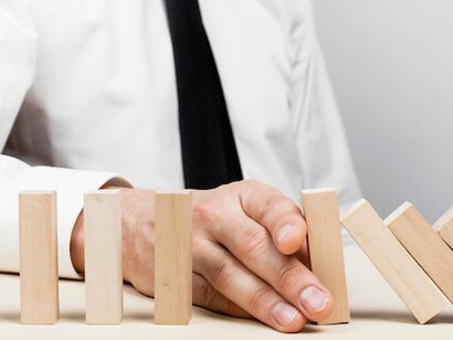 Man preventing wooden pieces from falling, representing the journey of learning from mistakes, self-discovery, and personal growth
