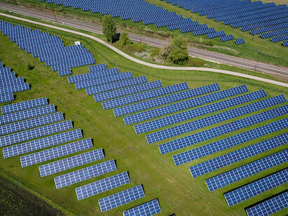 An image depicts a trio of sleek solar panels aligned perfectly, basking in the sunlight as they diligently convert its energy into a sustainable source of power