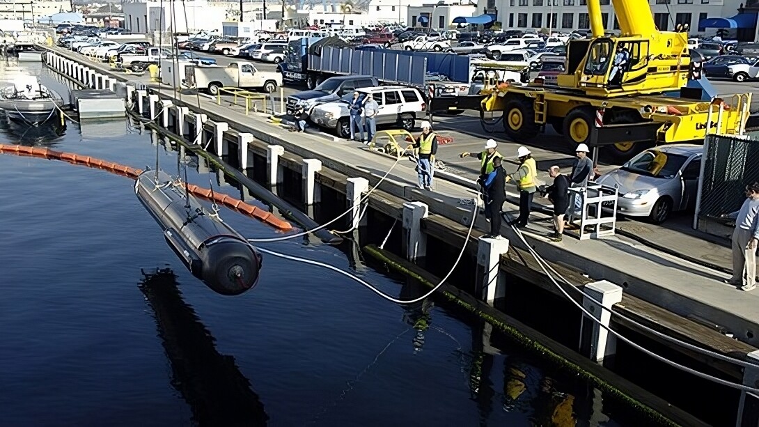 The Seahorse-class Autonomous Underwater Vehicle (AUV) from the applied research laboratory at Penn State University is lowered into the water prior to undergoing launch and recovery testing