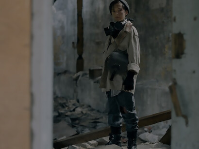 Within a foreboding glimpse into the future, a solitary child wanders through the remnants of a dilapidated structure, an oxygen mask casually draped around her neck, encapsulating the somber essence of desolation