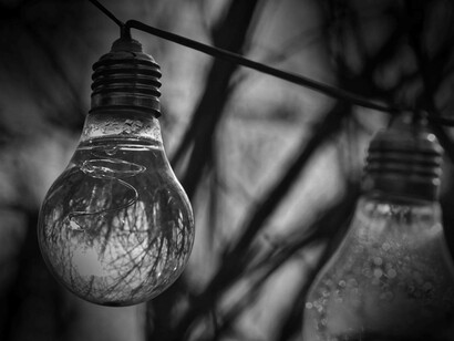 Two lightbulbs being suspended and storing water as a reference to the question "can water store energy"