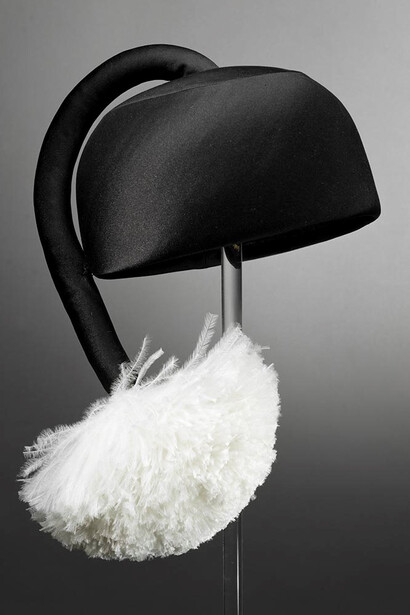 Halston, Hat with Tasseled Pom-Pom, c. 1967, black silk ribbon, white ostrich feathers, black grosgrain ribbon, and hair combs, the Museum of fine Arts, Houston, the Rienzi Collection, gift of Mr. and Mrs. Harris Masterson III.