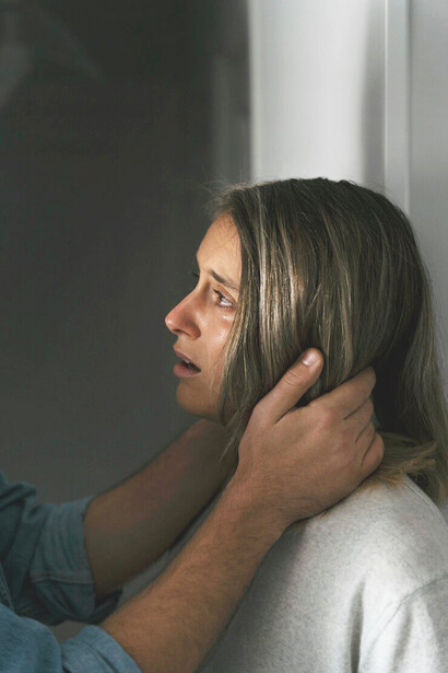 A scene of domestic violence at home, where a man and woman are engaged in a fight, surrounded by fear and psychological trauma