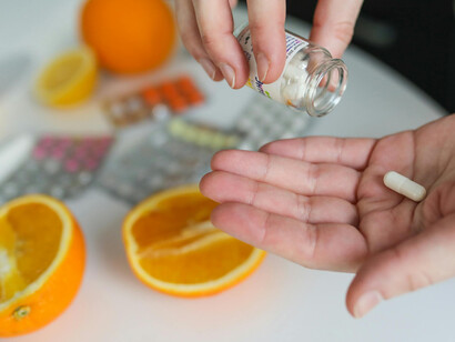 Sliced oranges and several pill blisters