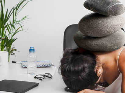 A person carrying a heavy load of rocks, representing the impact of mental filtering on personal growth and well-being