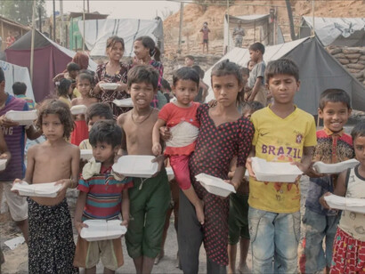 Climate-related disasters will push even more Brazilians into further poverty; children receiving food hand-outs in the favelas of Brazil