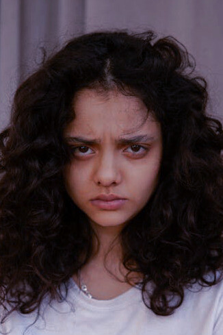 A girl's pondering gaze captures the essence of the question "Why?", reflecting on its multifaceted nature and the layers of understanding it unravels, from surface-level inquiries to profound philosophical contemplation