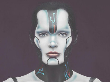 A close-up portrait of a woman with creative makeup and light effects, posing against a dark, textured background