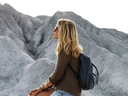 Woman take a rest from hiking on the rock