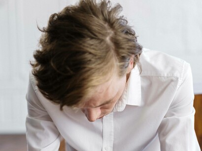 Man looks down in shame