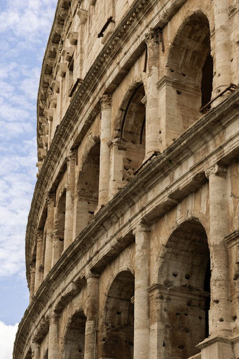 The arches of the Colosseum in Rome, Italy, stand as timeless sentinels, framing the grandeur and drama of ancient gladiatorial contests that once captivated audiences