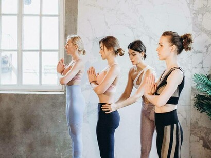 A yoga instructor helping her class reach the right from in her soul-aligned business