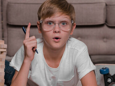 A boy diligently writes in his agenda, reflecting critical thinking skills and demonstrating the value of creative problem-solving for young learners