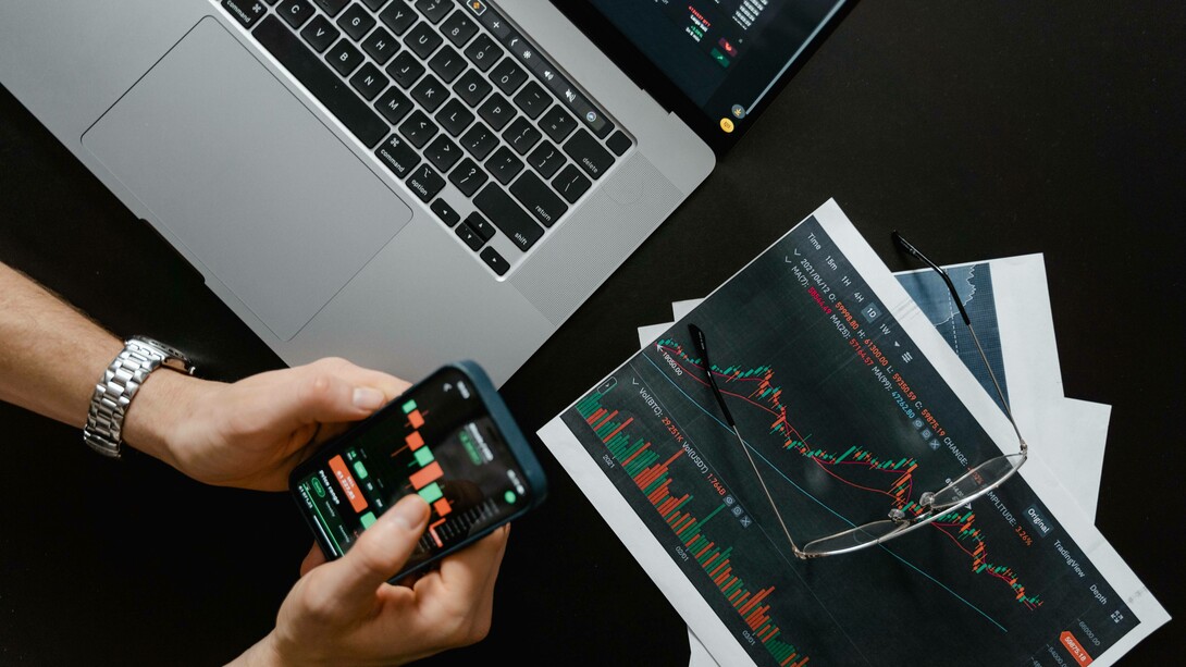 Man navigates investment options on his phone