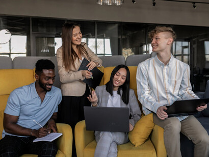 A group of coworkers engaged in a mentoring session, sharing experiences and insights, fostering a culture of empowerment and resilience against the crippling effects of self-doubt