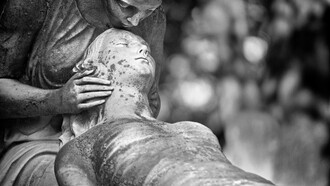 Black-and-white image of a guardian angel statue in Montréal, Quebec, Canada