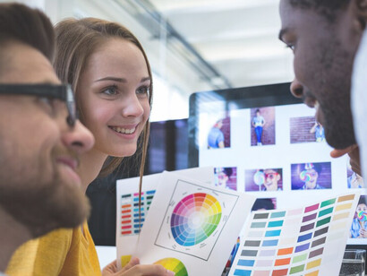 Office workers utilizing color psychology with a color palette, strategically applying hues to enhance productivity and atmosphere