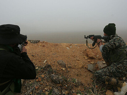 Men holding a weapon, fighting in the ongoing conflict against Bashar al-Assad's opponents, Syria