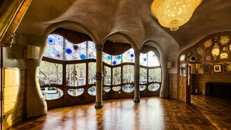 Barcelona, Spain, the interior of Casa Batlló featuring a decorative ceiling and large windows, showcasing Antoni Gaudí’s distinctive design style