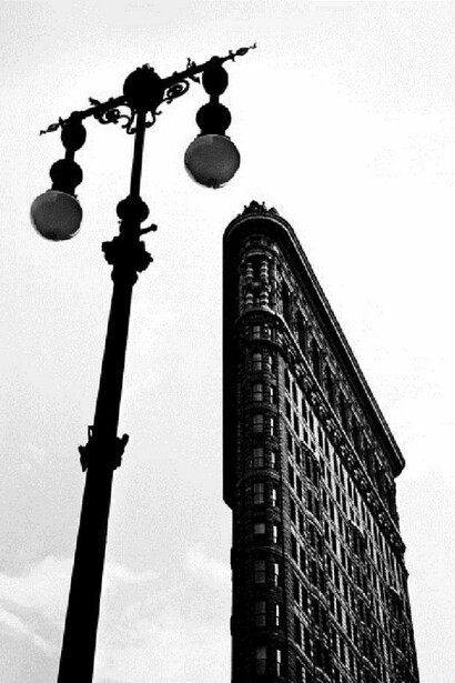 Low-angle view of the Flatiron Building framed by a street lamp, New York, New York, 1947. (Photo by Fred Stein Archive/Archive Photos/Getty Images)
