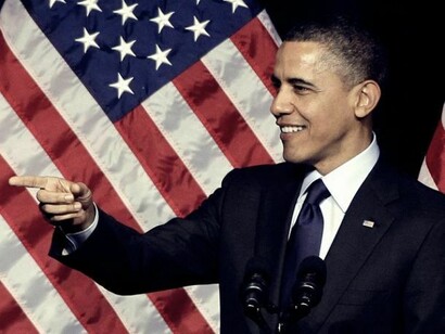 Obama, smiling during a meeting