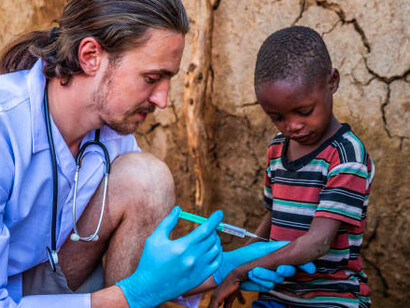 A dedicated doctor from Doctors Without Borders checks the health of a young child, reflecting the organisation's pivotal role in global healthcare, especially in regions affected by crisis and instability