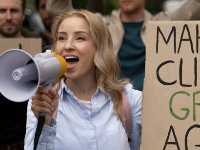 A young woman leads a protest for climate change awareness