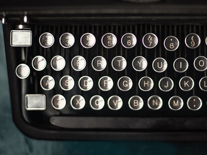 Typewriter's keys on a blue desk