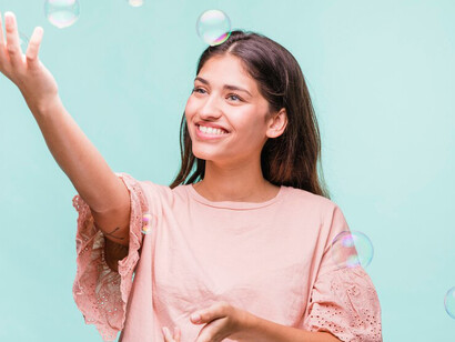 A cheerful girl joyfully chases after vibrant soap bubbles, her laughter filling the air with a sense of pure happinesss
