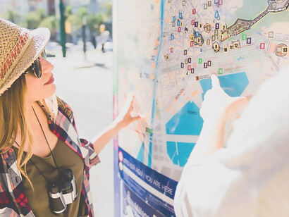 Lost couple navigates the city streets, consulting a map to find their way, a common scenario for urban explorers