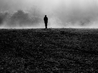 A lonely individual in a field caused by population decline