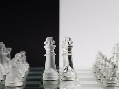 Stylish transparent chess pieces on a sleek chessboard set