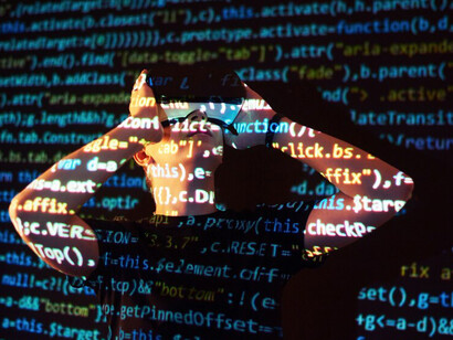 The future of language learning with a double exposure of a man in a VR headset and lines of code, illustrating the dynamic between human and AI translation